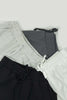 A group of three shorts sitting next to each other