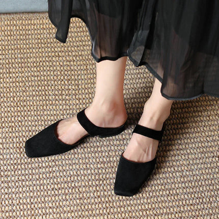 Chanclas planas retro sencillas de versión Müller negras de ante estilo minimalista