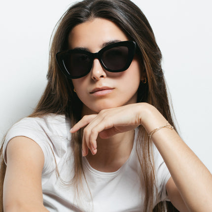 Gafas de sol Hanukeii® Isla Tortuga Black / Black en modelo femenino con fondo blanco.